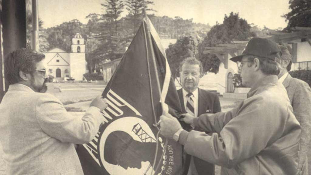 Robert Lagomarsino raising POW/MIA flag with veterans