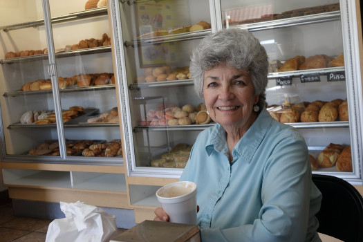 Carmen Ramirez having a coffee at a donut shop.